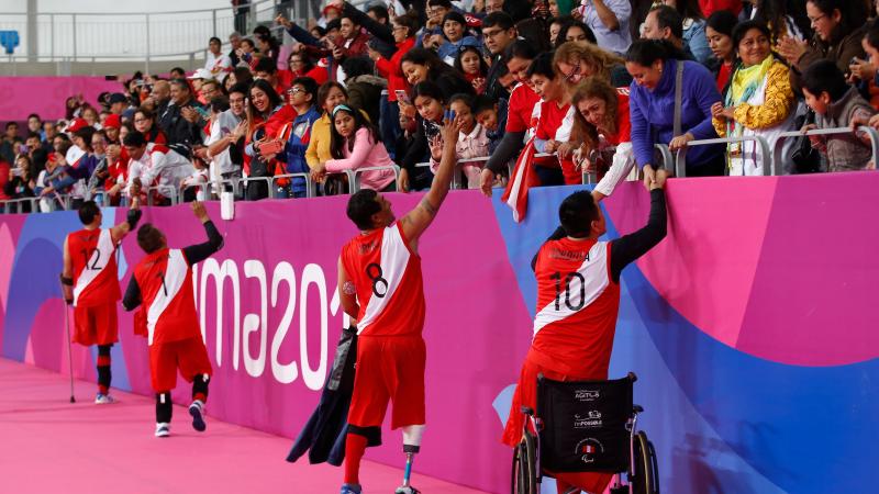 Peruvian sitting volleyball players cheered by the crowd