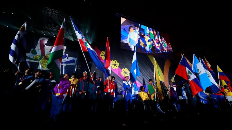 a group of athletes holding national flags