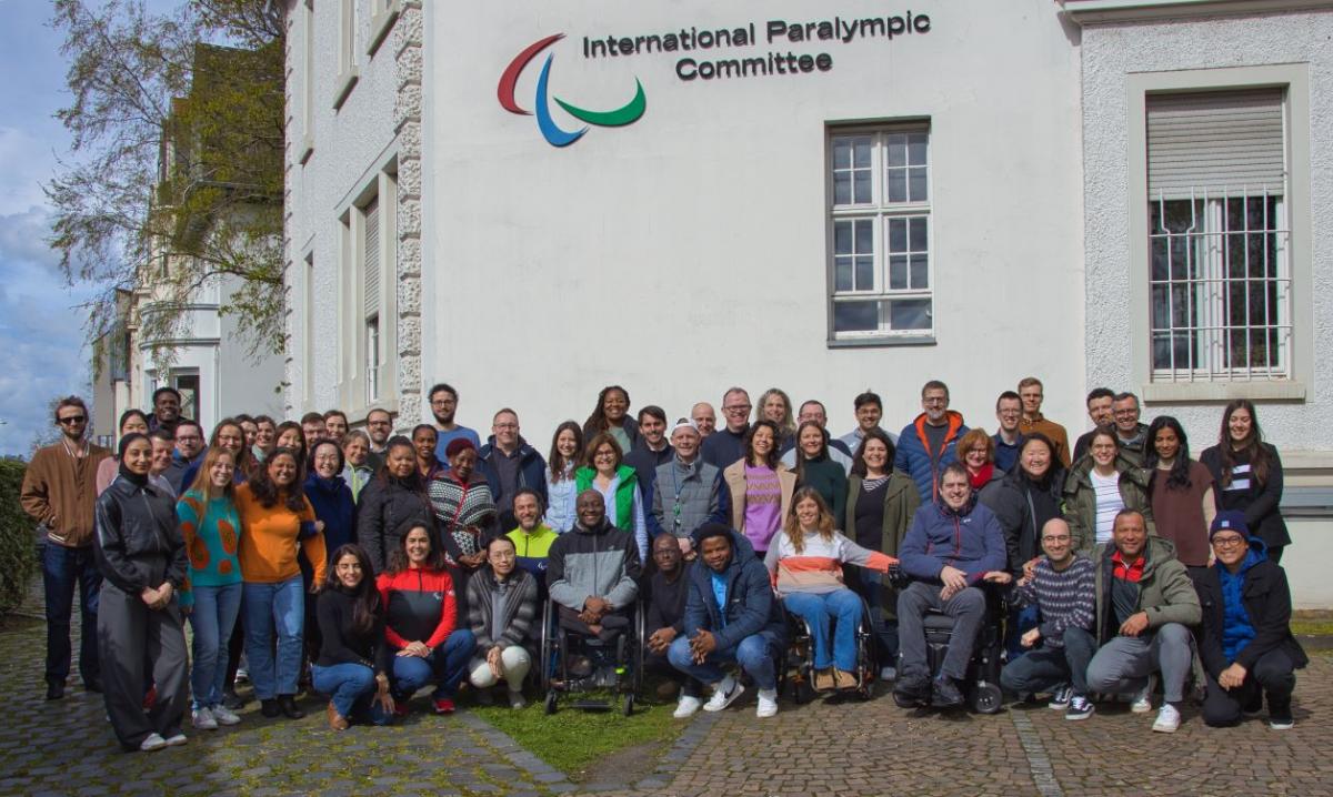 About 60 IPC staff pose for a photo in front of the IPC headquarters in Bonn.