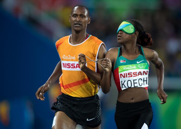 Kenyan track athlete and her guide running
