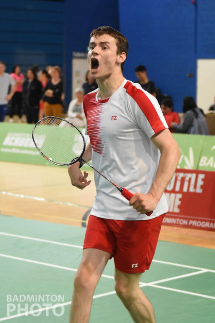 English male badminton player celebrates after a point