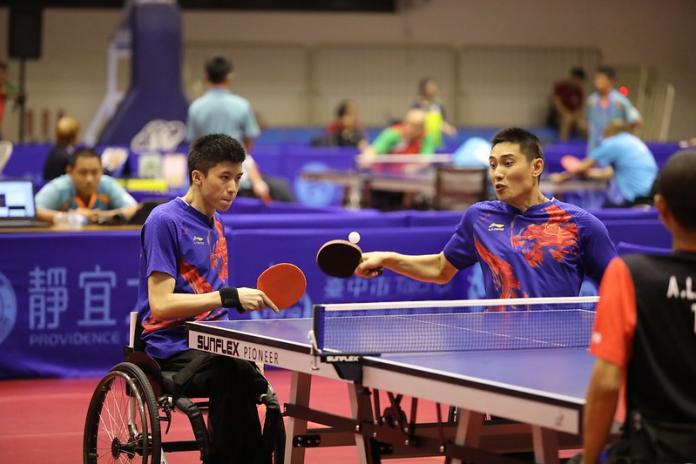 Two male Chinese table tennis players play together in doubles