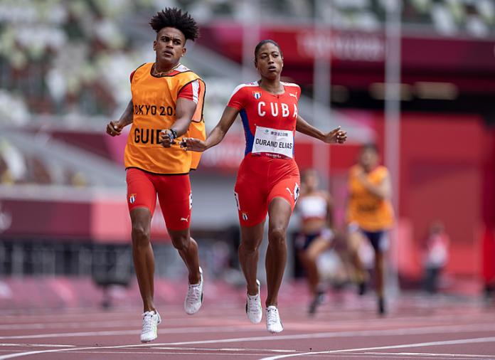 Cuban sprinter Omara Durand and her guide heading into the finish line of the 400m