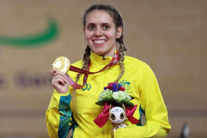 Australian track cyclists smiles with gold medal