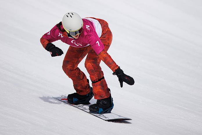 Lisa Dejong crouches as she speeds down the snowboard cross courseOIS