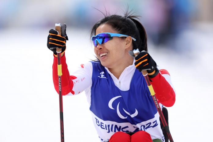 Yang Hongqiong celebrates after crossing the finish line in the women's sprint sitting