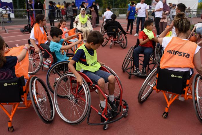 A group of children in wheelchairs get ready to try out wheelchair basketball.