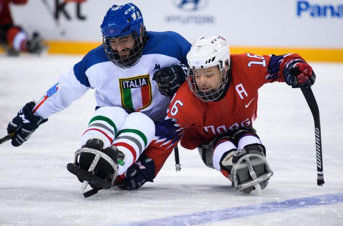 Two male Para ice hockey players compete at PyeongChang 2018.