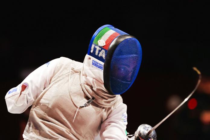 A female athlete competing in wheelchair fencing