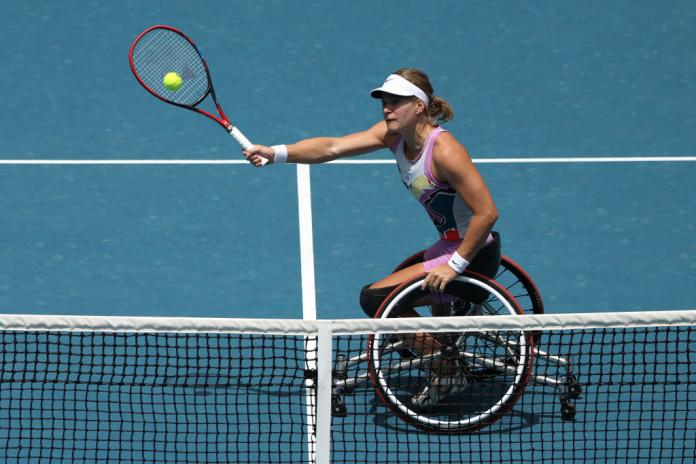 A female wheelchair tennis plays a forehand at the Australian Open.