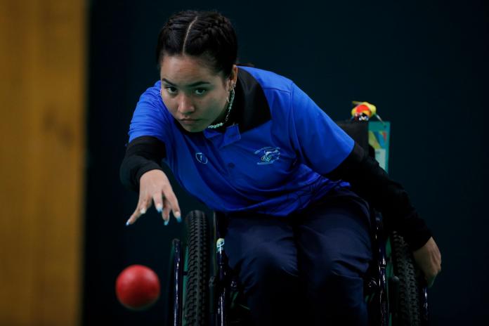 Rebeca Duarte, a boccia athlete from El Salvador, throws a red ball during competition.