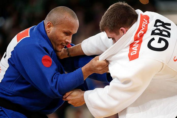 Two male judokas grapple during competition at London 2012.