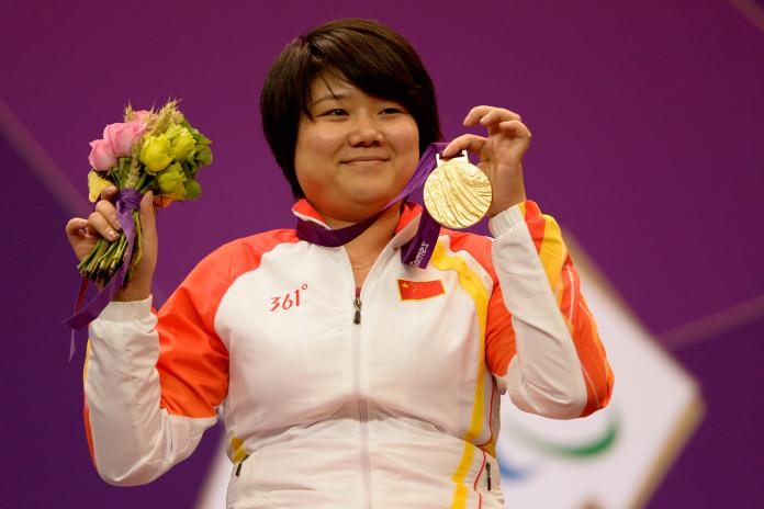 Zhang Cuiping celebrates with her gold medal