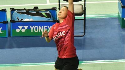 a female Para badminton player reaches for a shot