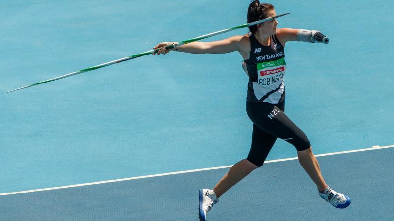 a female athlete with one arm prepares to throw a javelin