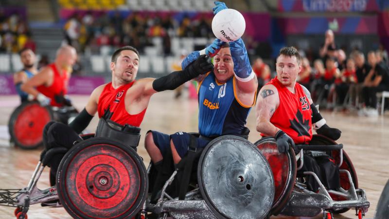 male wheelchair rugby players fight for the ball