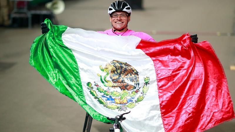 male wheelchair athlete wrapped in a Mexico flag