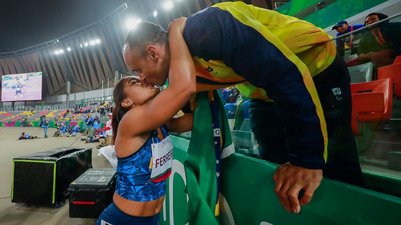two Para athletes kissing