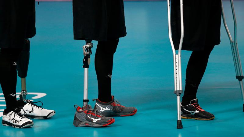 three athletes legs', some with prosthetics