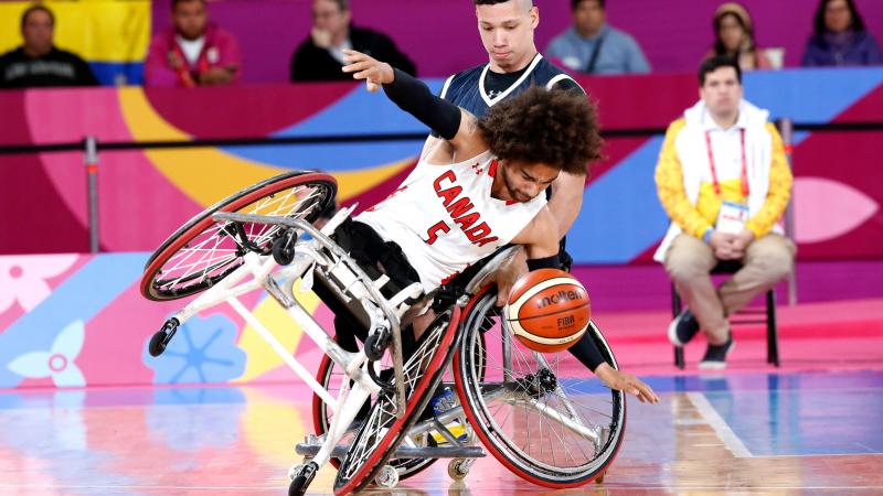 male wheelchair basketball player tipping over