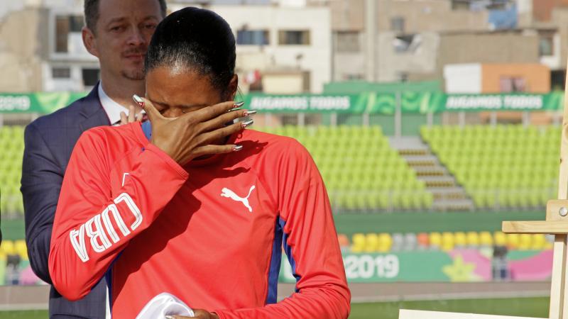 a female Para athlete cries holding her eyes