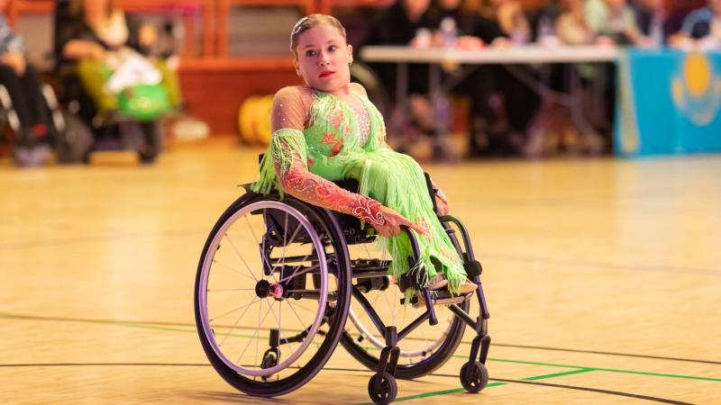 Young female Polish dancer in wheelchair looks on
