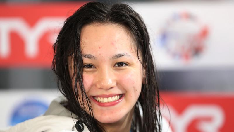a female Para swimmer smiling