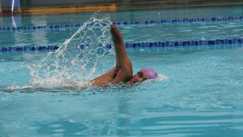 a male Para swimmer during freestyle