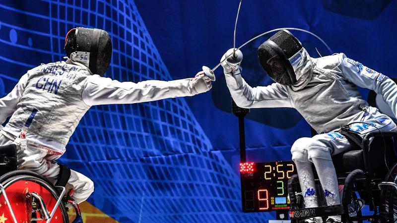 Two wheelchair fencers battling