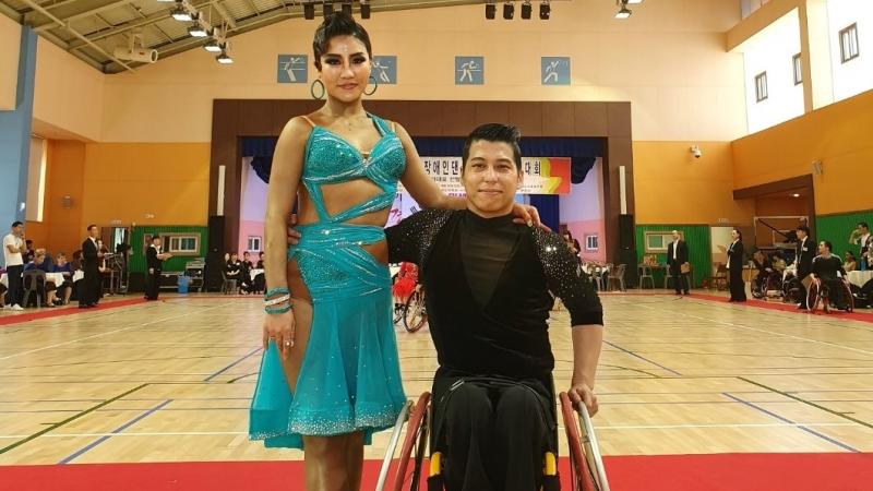 Male Korean wheelchair dancer poses with female standing partner