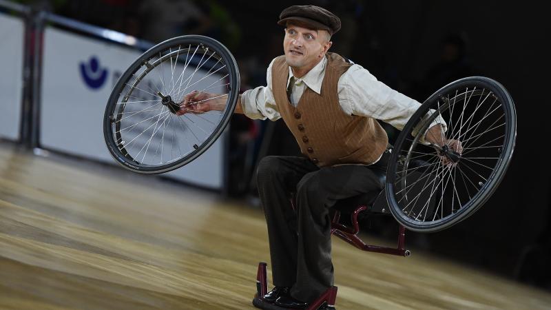 Male Para dance removes wheels in wheelchair