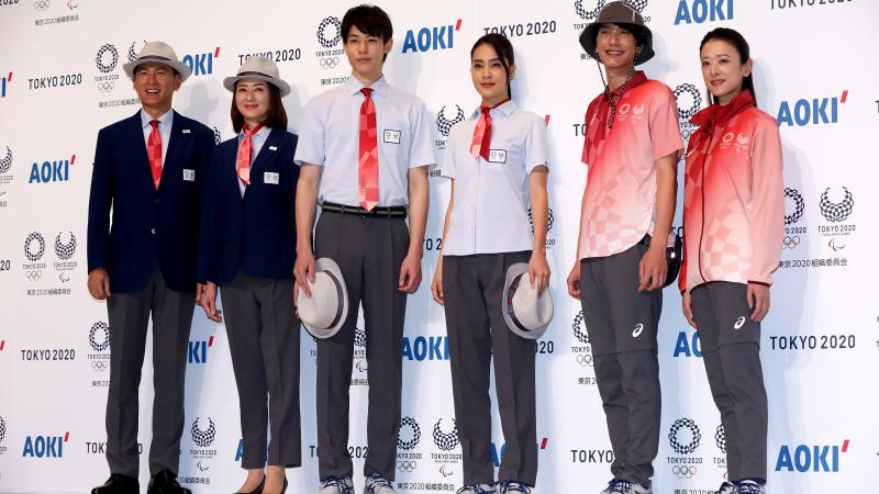 Models posing with Tokyo 2020 technical officials uniforms
