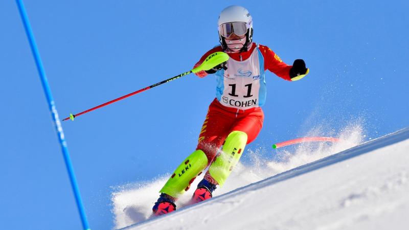 Chinese standing skier comes down the mountain