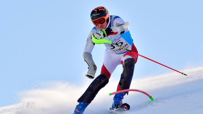 Male standing skier makes  turn