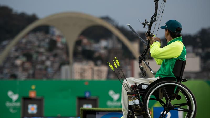 Brazilian male archer in his wheelchair aiming at the target