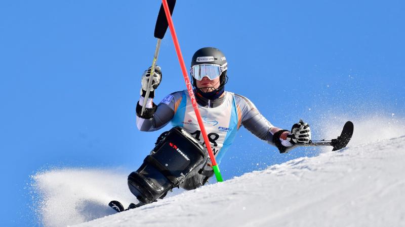 Male sit-skier competes in the slalom