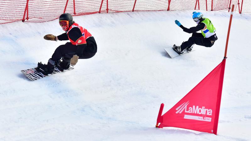 Two male Para snowboarders competing