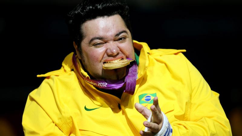 Male boccia player bites his Paralympic gold medal