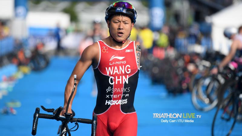 Chinese male with left arm amputation transitions to bike segment of triathlon