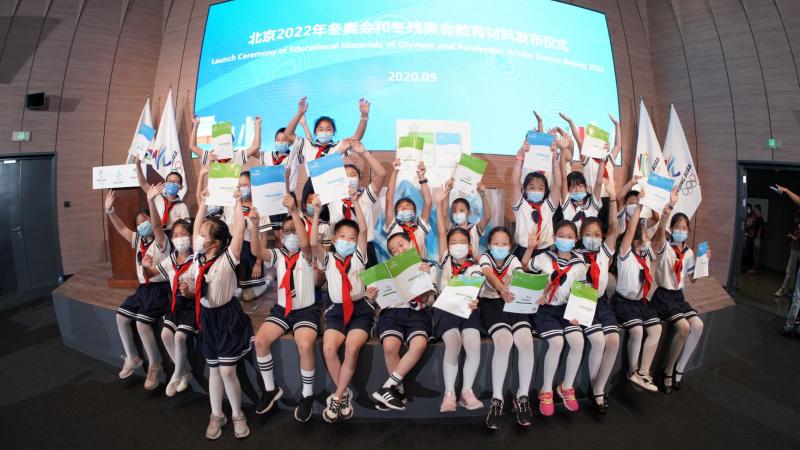 Chinese school kids with hands in the air
