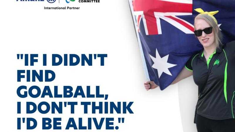 Vision impaired woman holding Australian flag with branded text on the side 