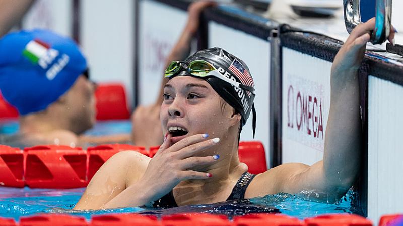 Gia Pergolini shocked in the pool with a black swim cap as she wins her final