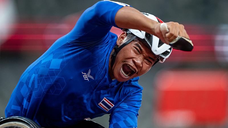 Thai wheelchair racer Pongsakorn Paeyo celebrates after crossing the finish line