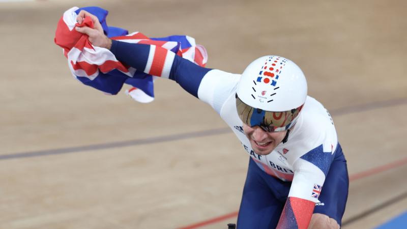 VICTORY LAP: Jaco van Gass of Great Britain celebrates after winning gold medal in the Track Cycling Men's C3 3000m Individual Pursuit race at Tokyo 2020 Paralympic Games. 