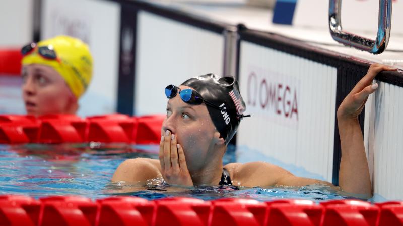 A female swimmer with a surprised expression in the pool