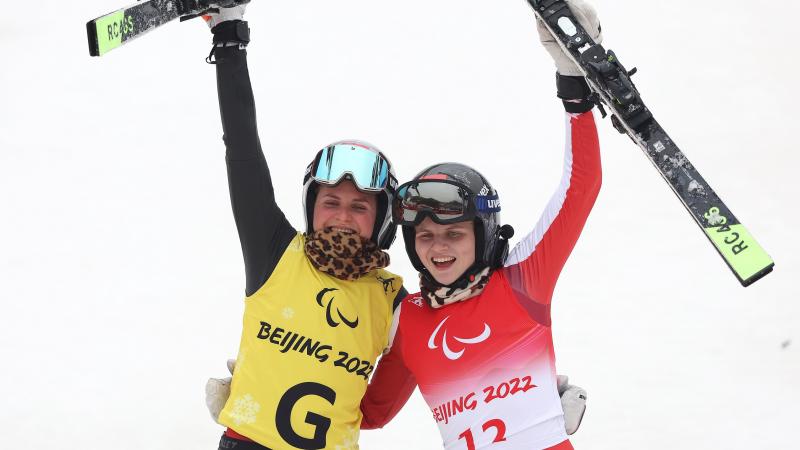 Veronika Aigner and guide and sister Elisabeth Aigner react after winning the giant slalom gold medal