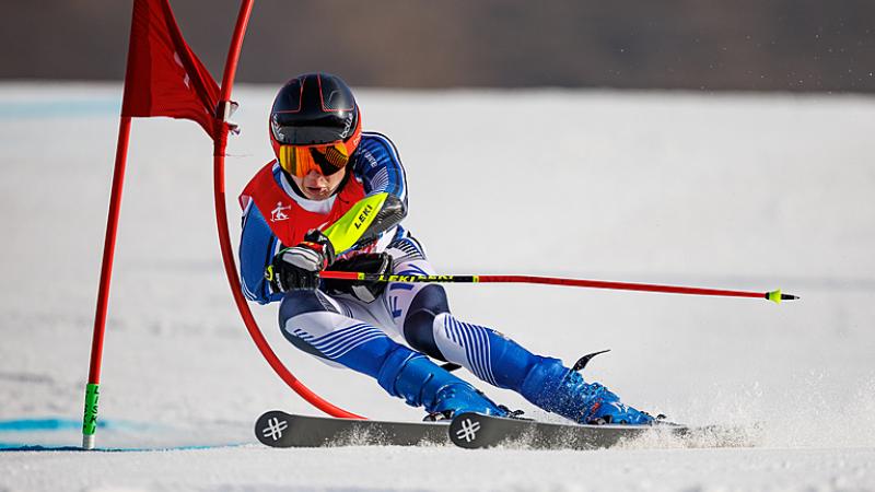 Finland's Santeri Kiiveri skis past a gate at Beijing 2022