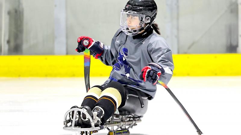 A female Para ice hockey player on a rink