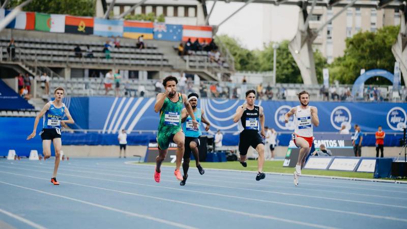 Five male sprinters in a Para athletics race