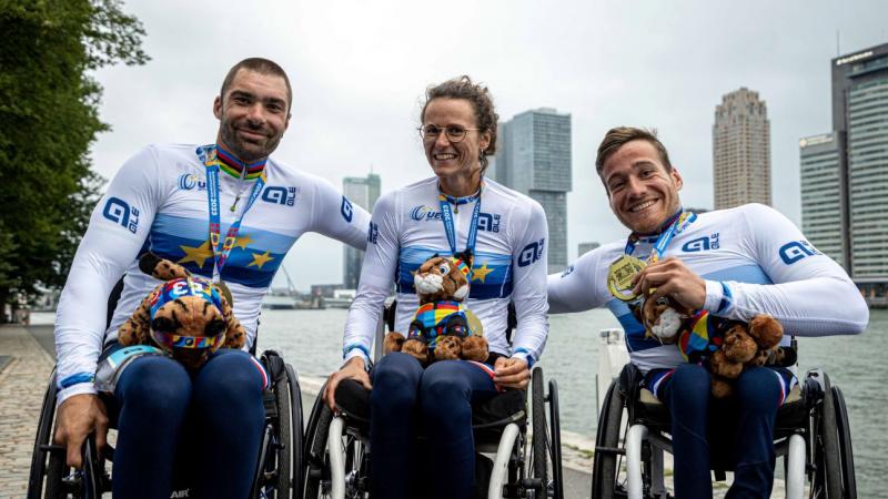 Three Para athletes posing for a photo after receiving gold medals and a European champion shirt